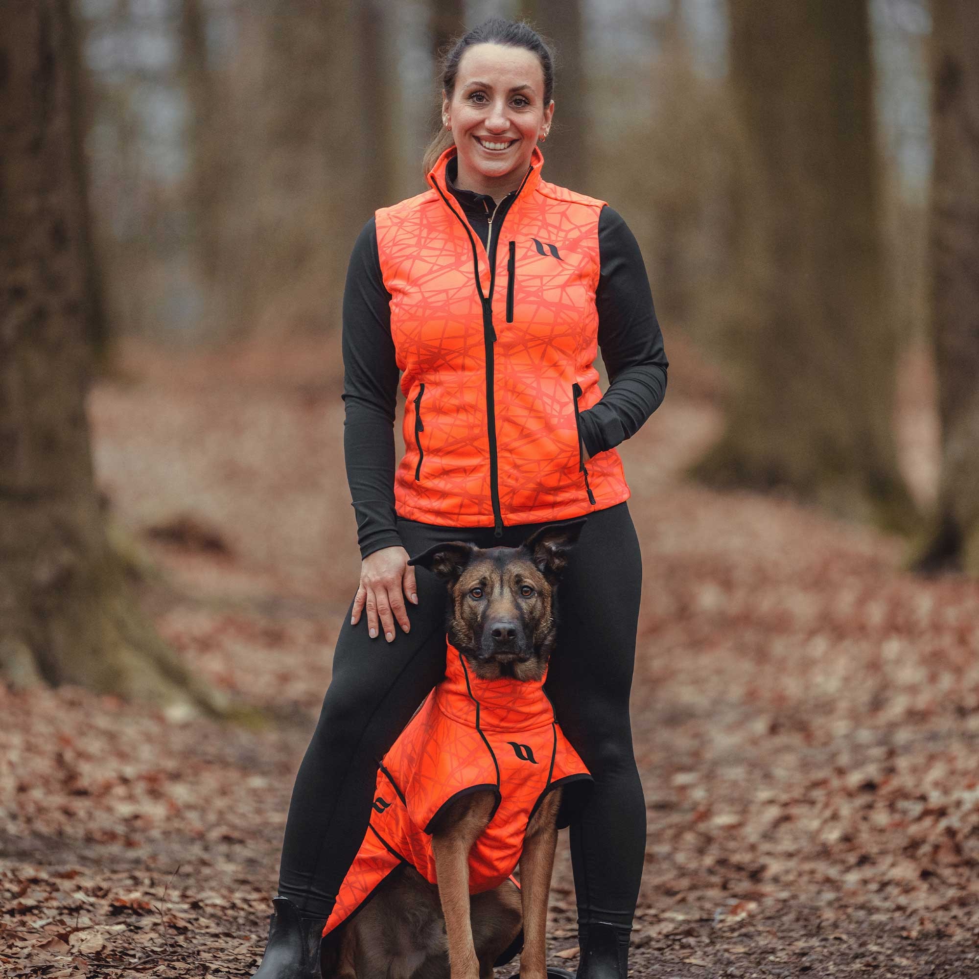 FLASH Damenweste in Orange, getragen beim Spaziergang mit Hund im Wald
